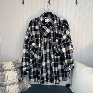 Black and white flannel with fringe on the back